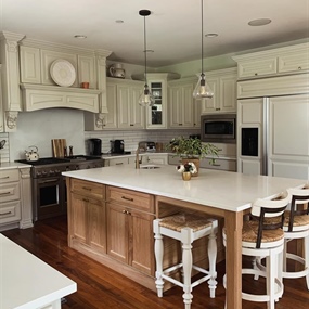 Clarendon Hills kitchen cabinet painting and refacing project featuring light beige cabinets, white oak island veneer, and quartz countertops